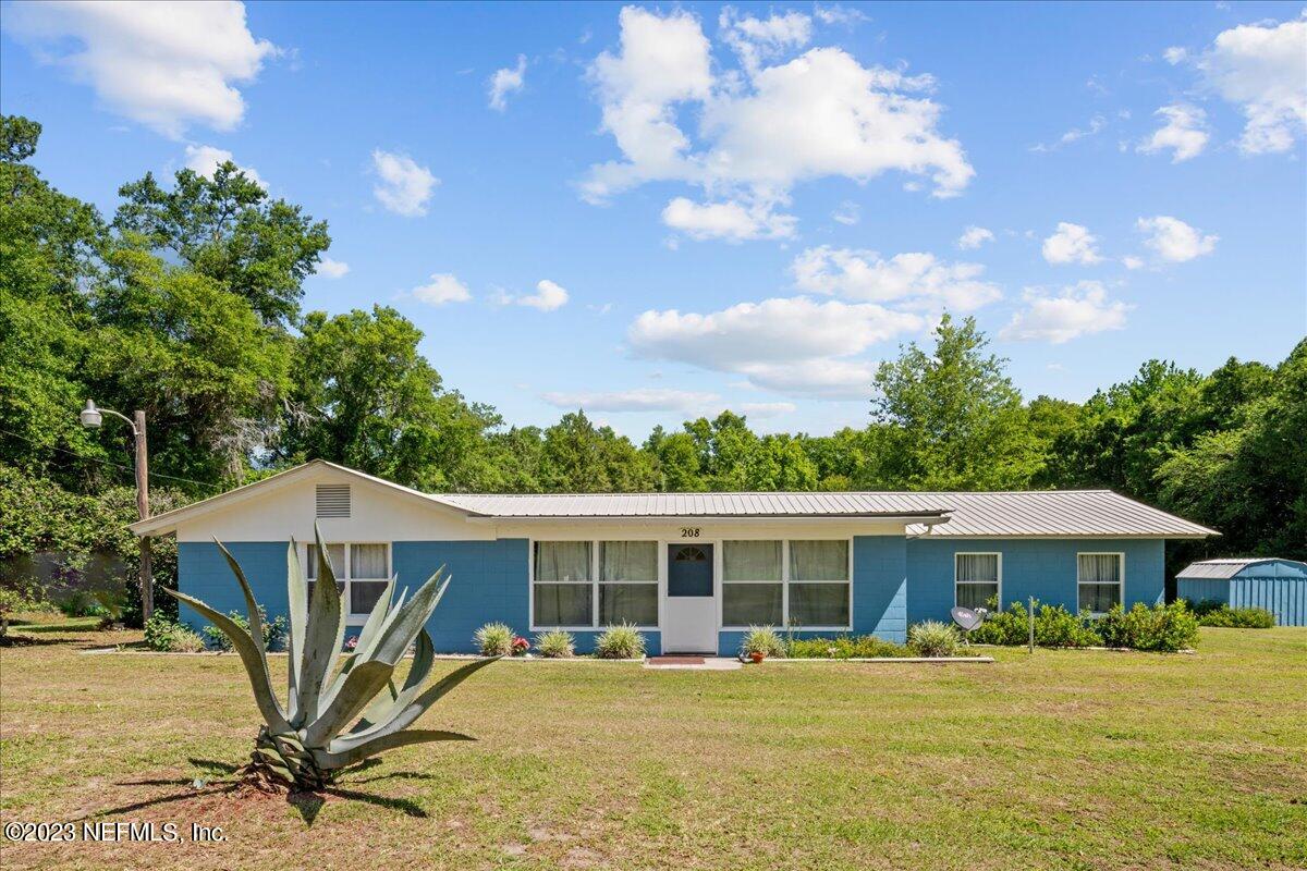 208 Tinsley Road Florahome, FL 32140 - Photo 1 of 71 a front view of a house with a yard and potted plants