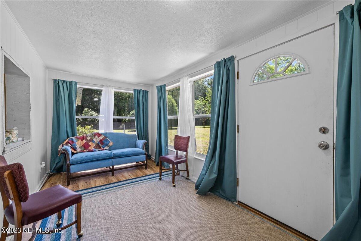 208 Tinsley Road Florahome, FL 32140 - Photo 11 of 71 a living room with furniture and a gate