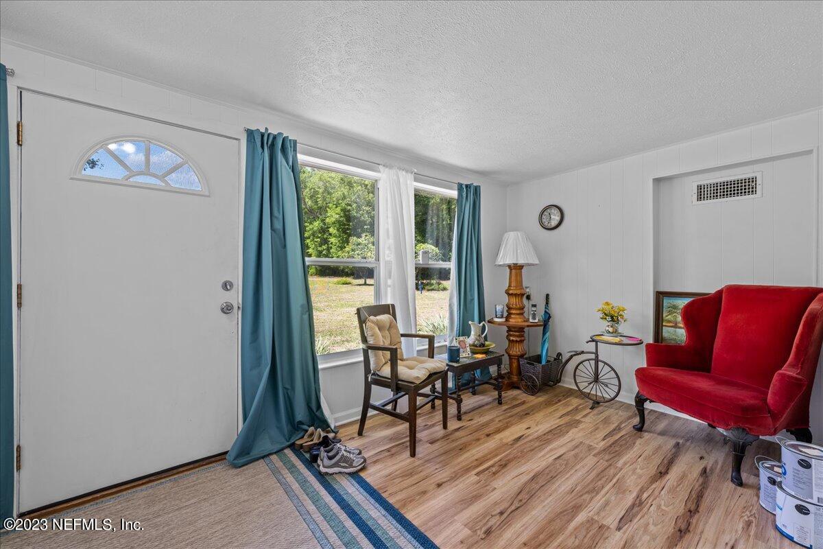208 Tinsley Road Florahome, FL 32140 - Photo 12 of 71 a living room with furniture and wooden floor