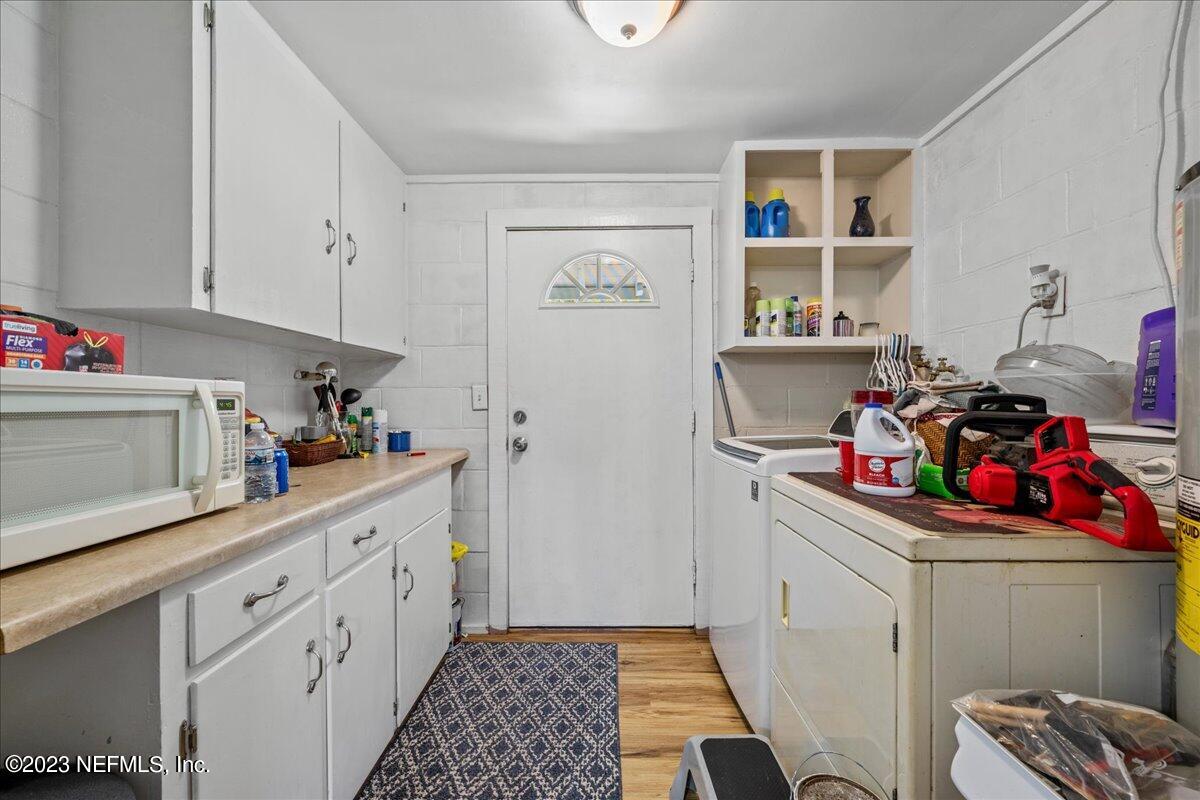 208 Tinsley Road Florahome, FL 32140 - Photo 19 of 71 a kitchen with a sink dishwasher stove and cabinets