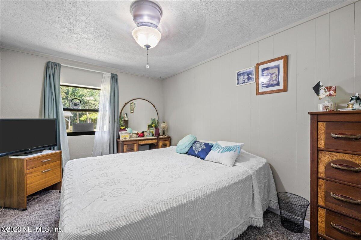 208 Tinsley Road Florahome, FL 32140 - Photo 21 of 71 a bedroom with a bed and a flat screen tv