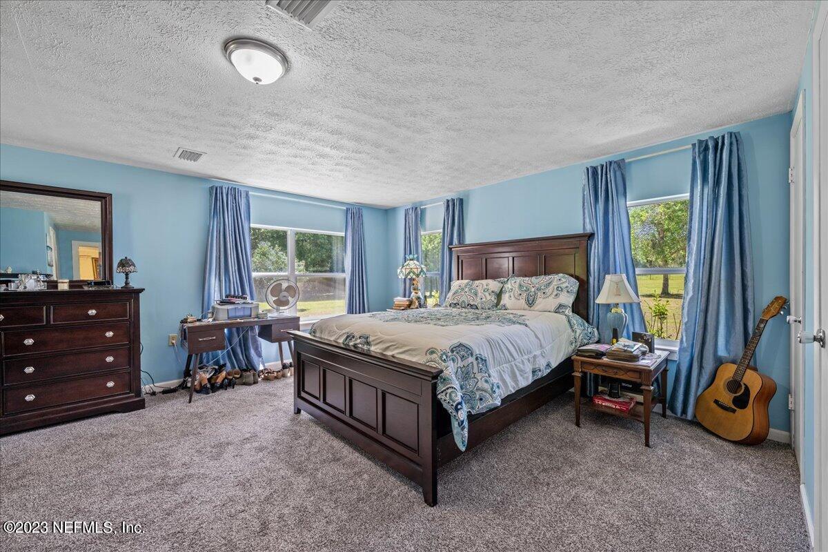 208 Tinsley Road Florahome, FL 32140 - Photo 22 of 71 a bedroom with a bed and a window