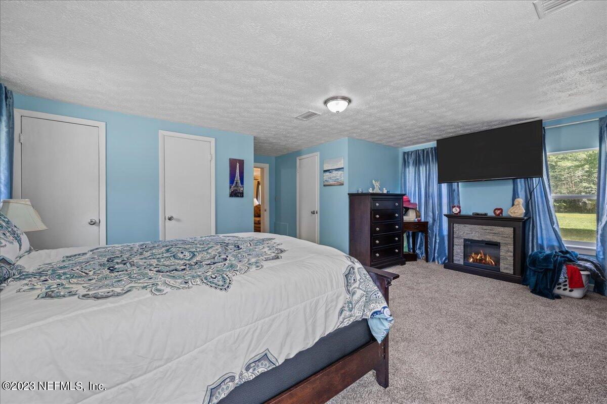 208 Tinsley Road Florahome, FL 32140 - Photo 23 of 71 a bed room with a bed and a television