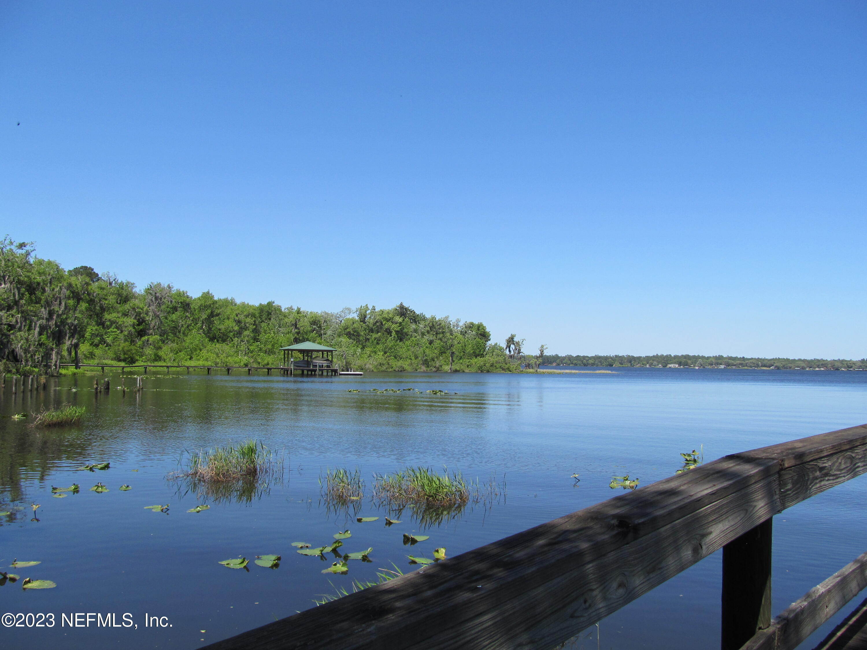 208 Tinsley Road Florahome, FL 32140 - Photo 47 of 71 a view of a lake with houses in the back