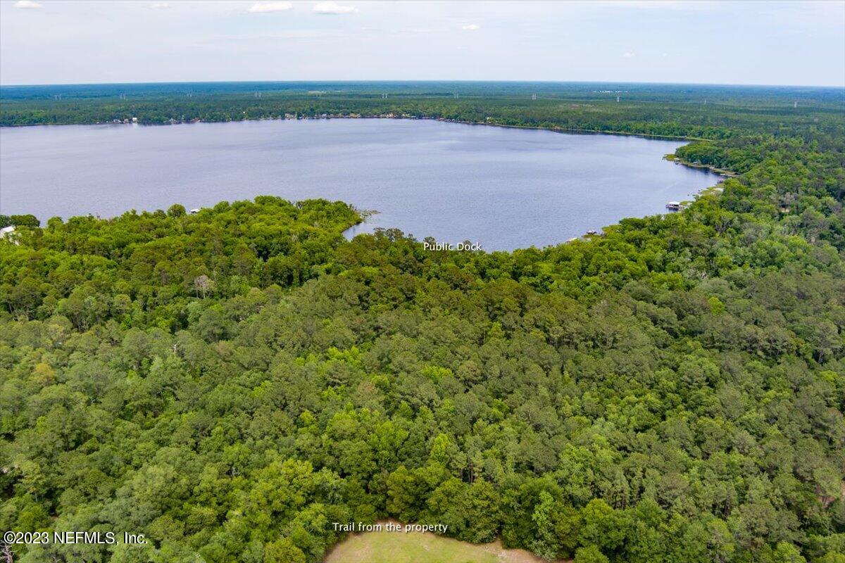 208 Tinsley Road Florahome, FL 32140 - Photo 70 of 71 a view of a lake with a field