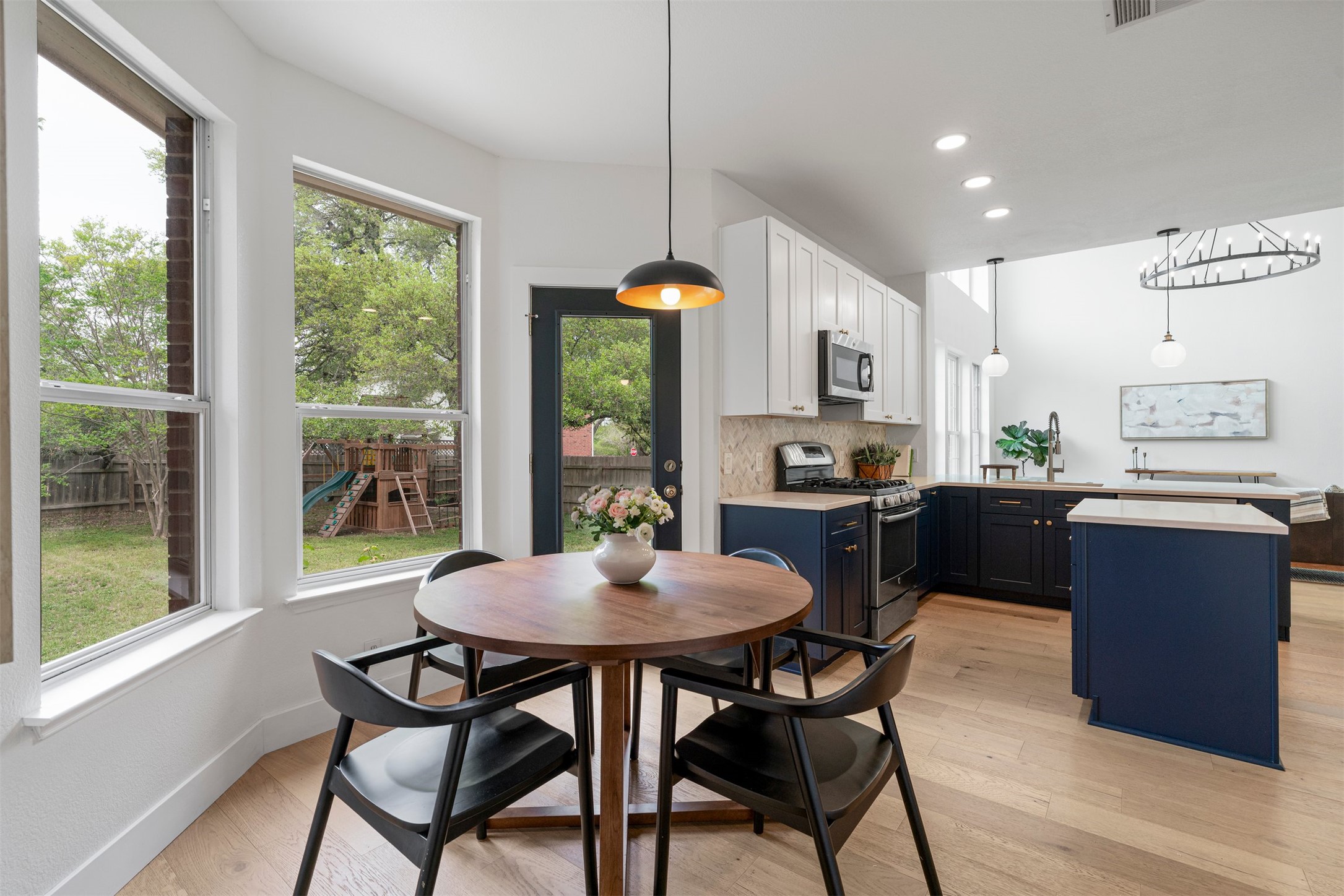 6804 Auckland Court Austin, TX 78749 - Photo 24 of 40 a kitchen with a table chairs and a wooden floor