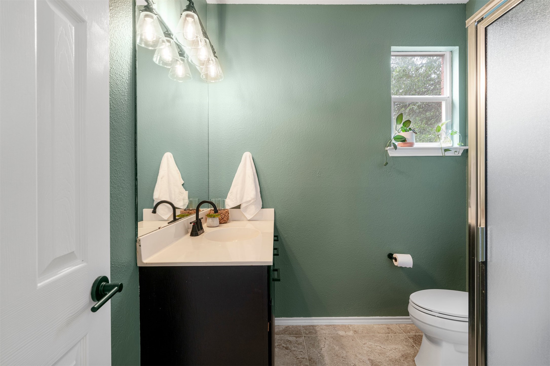 6804 Auckland Court Austin, TX 78749 - Photo 28 of 40 a bathroom with a sink and mirror with toilet
