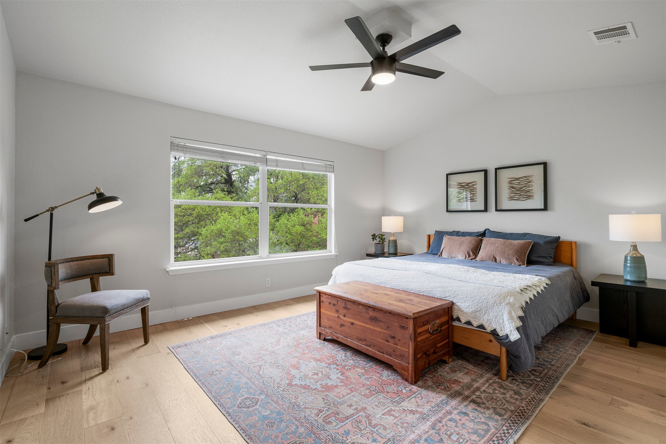 6804 Auckland Court Austin, TX 78749 - Photo 7 of 40 a spacious bedroom with a bed a couch and a window
