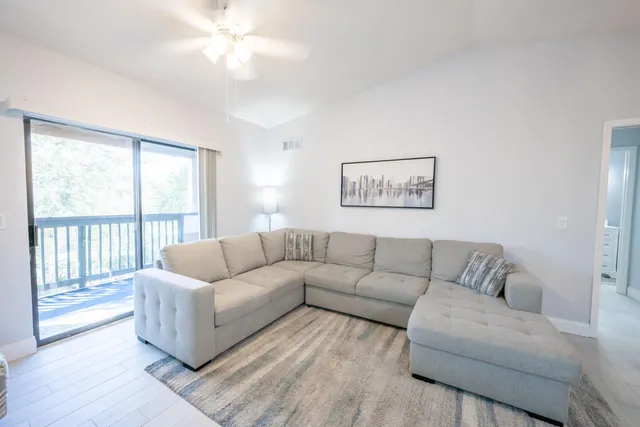 a living room with furniture and a large window