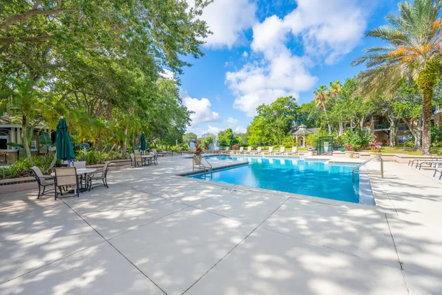 a view of swimming pool with outdoor seating and trees