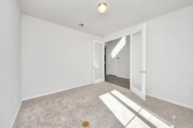 a view of a room with wooden floor and window