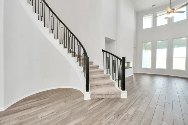 a view of staircase with wooden floor and a floor to ceiling window