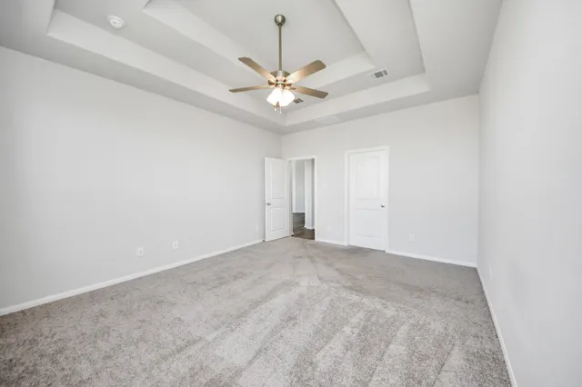 an empty room with chandelier fan
