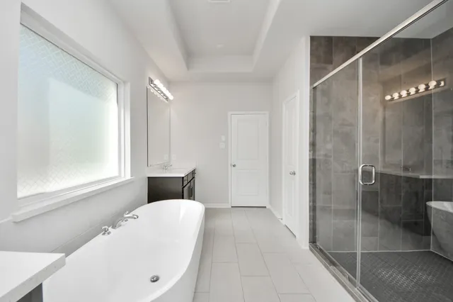 a bathroom with a bathtub and shower