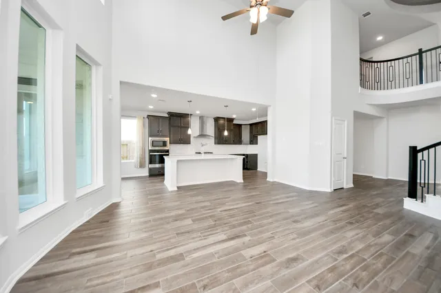 a view of kitchen and kitchen with granite countertop wooden floor