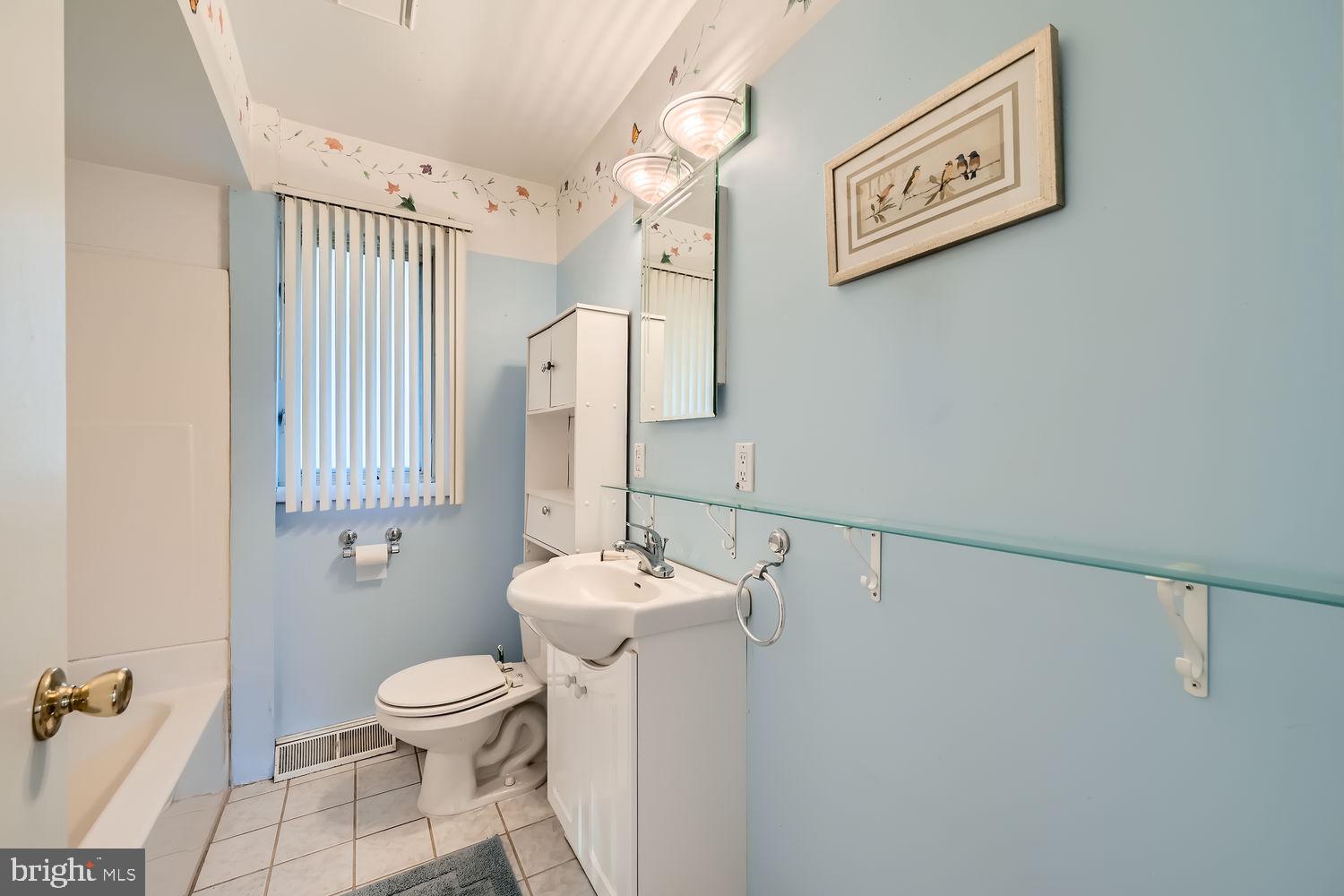 1410 Stepney Road Annapolis, MD 21409 - Photo 14 of 30 a white toilet sitting next to a bathroom sink