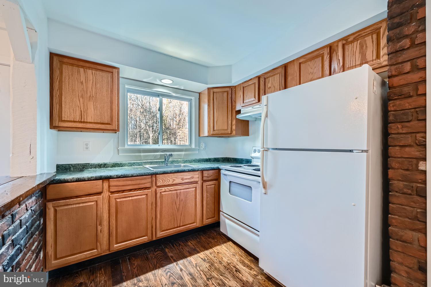 1410 Stepney Road Annapolis, MD 21409 - Photo 9 of 30 a kitchen with stainless steel appliances granite countertop a refrigerator sink and cabinets