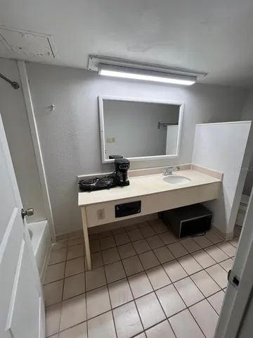 a bathroom with a sink a vanity and a mirror