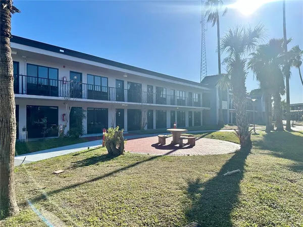 a view of a backyard with furniture