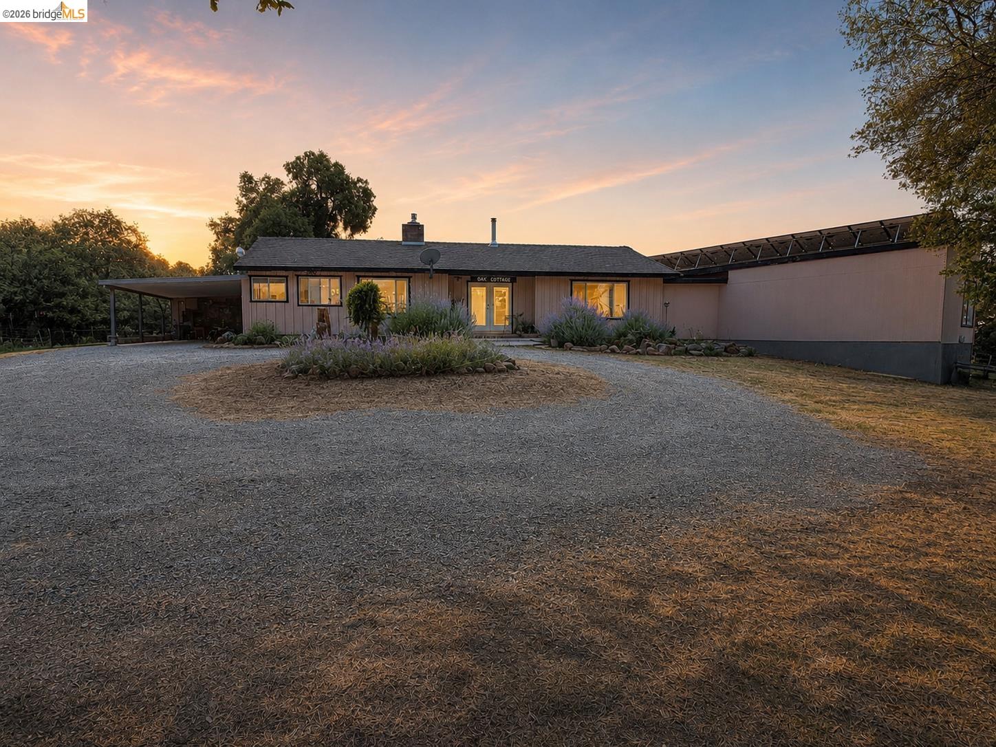18195 Wards Ferry Road Sonora, CA 95370 - Photo 2 of 67 Ranch-style residence featuring a gravel circular driveway, carport, and a prominent array of solar panels