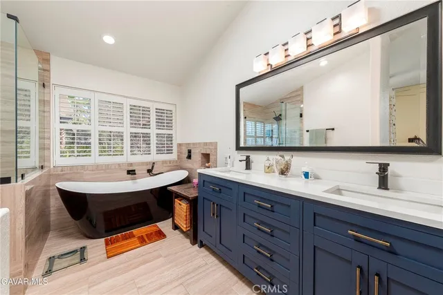 a bathroom with a sink a mirror and a shower