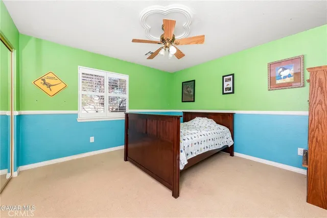 a bedroom with bed and a window