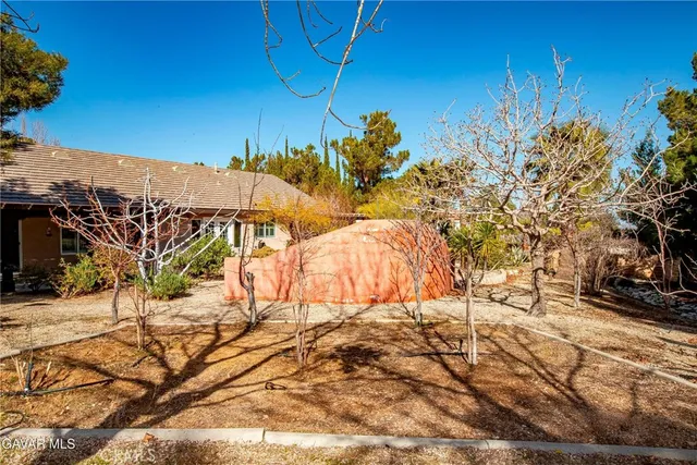 a backyard of a house with table and chairs