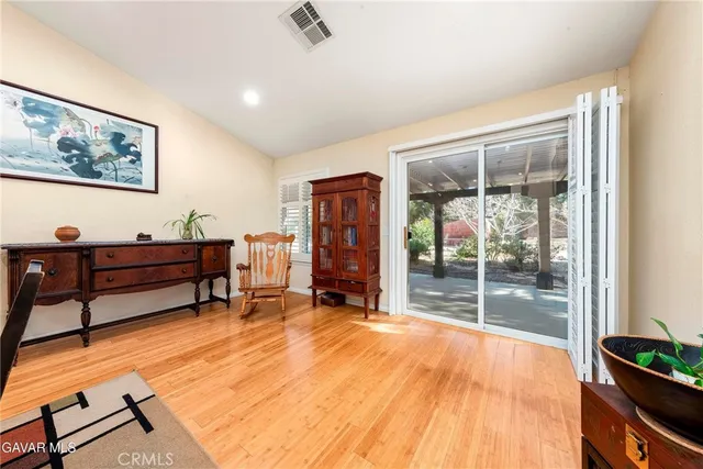 a kitchen with stainless steel appliances granite countertop a stove top oven a sink a dining table and chairs