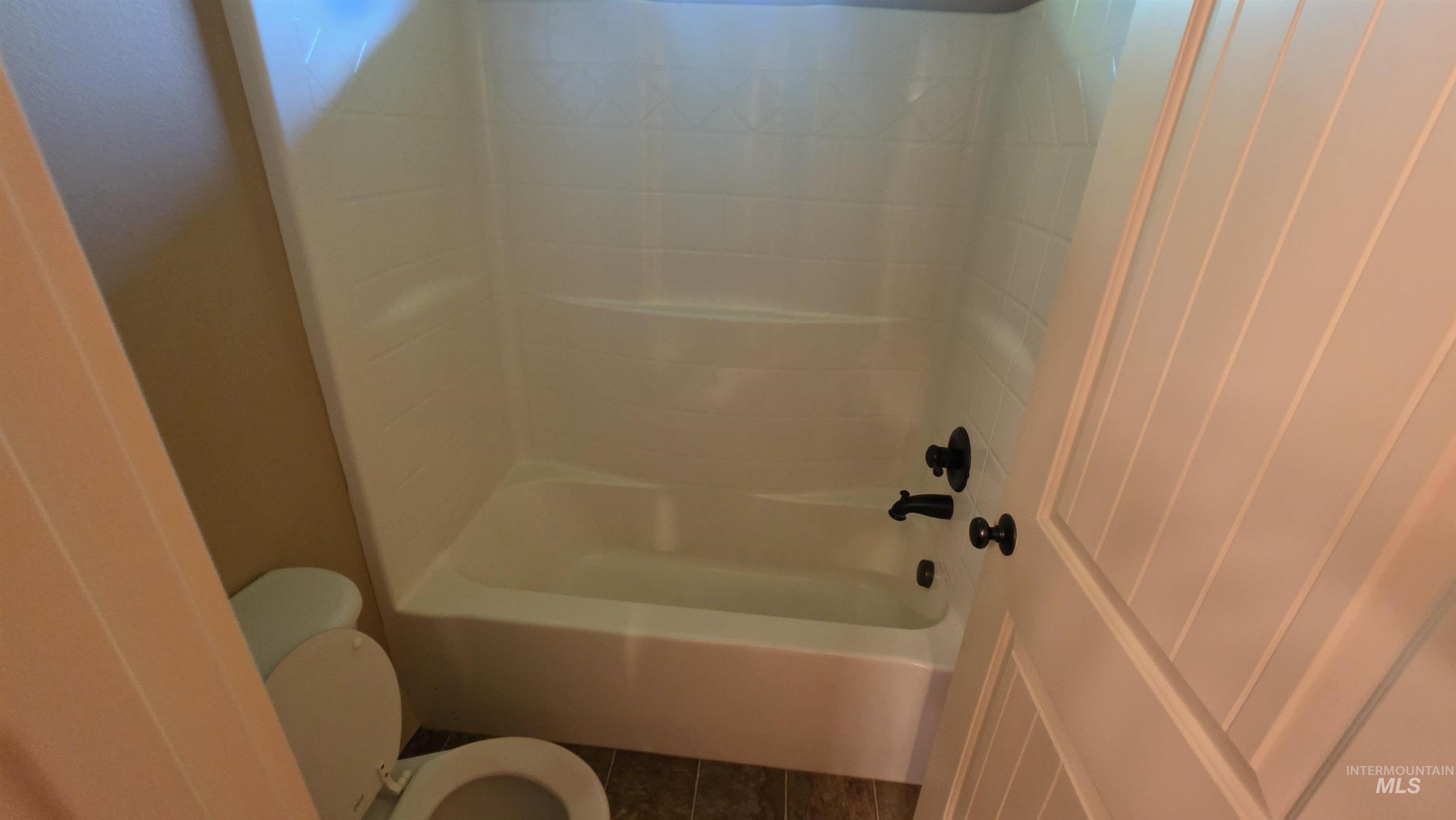 5239 West Morris Hill Road Boise, ID 83706 - Photo 11 of 19 White shower and tub combination featuring matte black fixtures