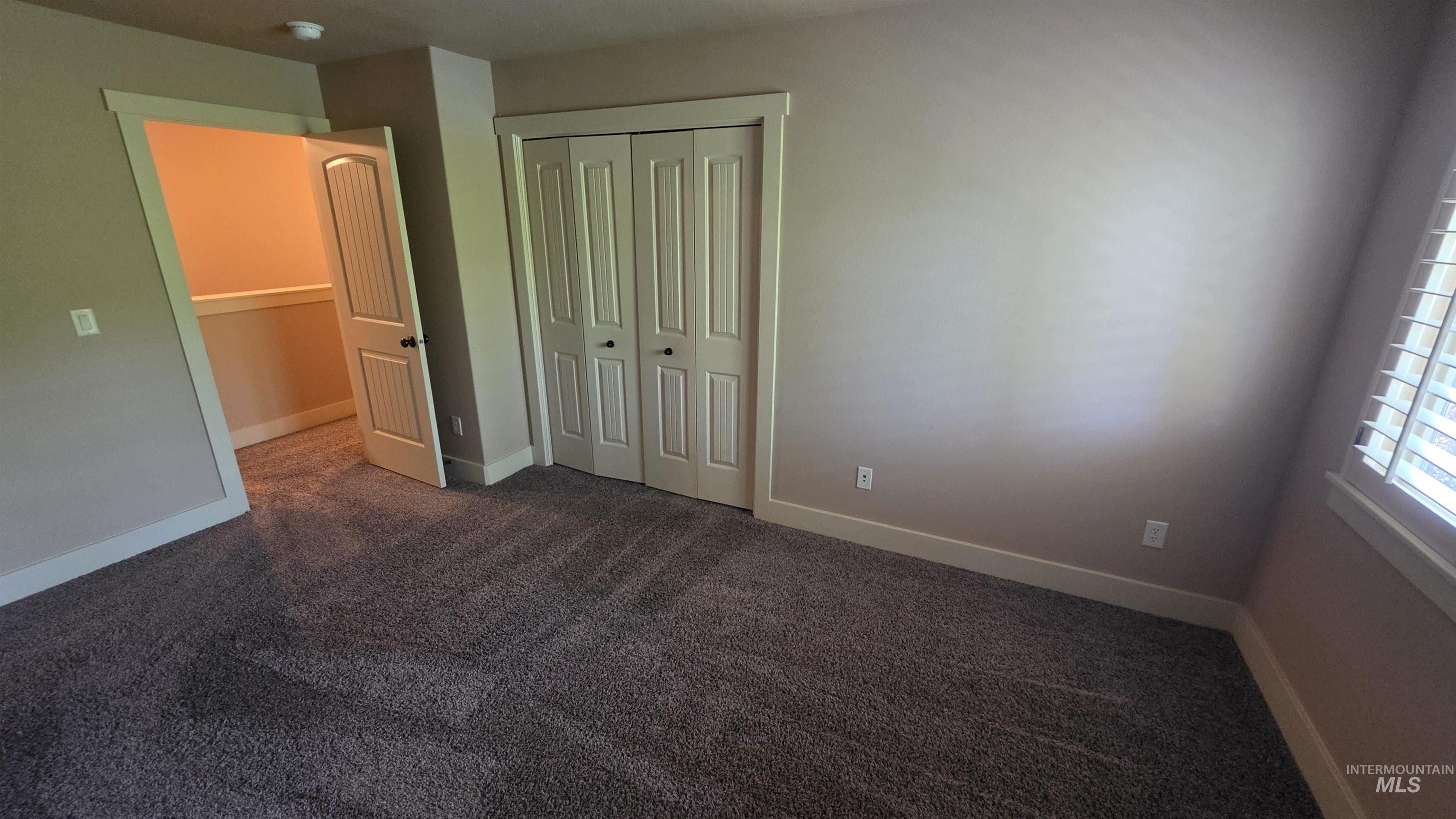 5239 West Morris Hill Road Boise, ID 83706 - Photo 18 of 19 Room featuring neutral-toned walls, plush grey carpeting, white baseboards, and white louvered window blinds