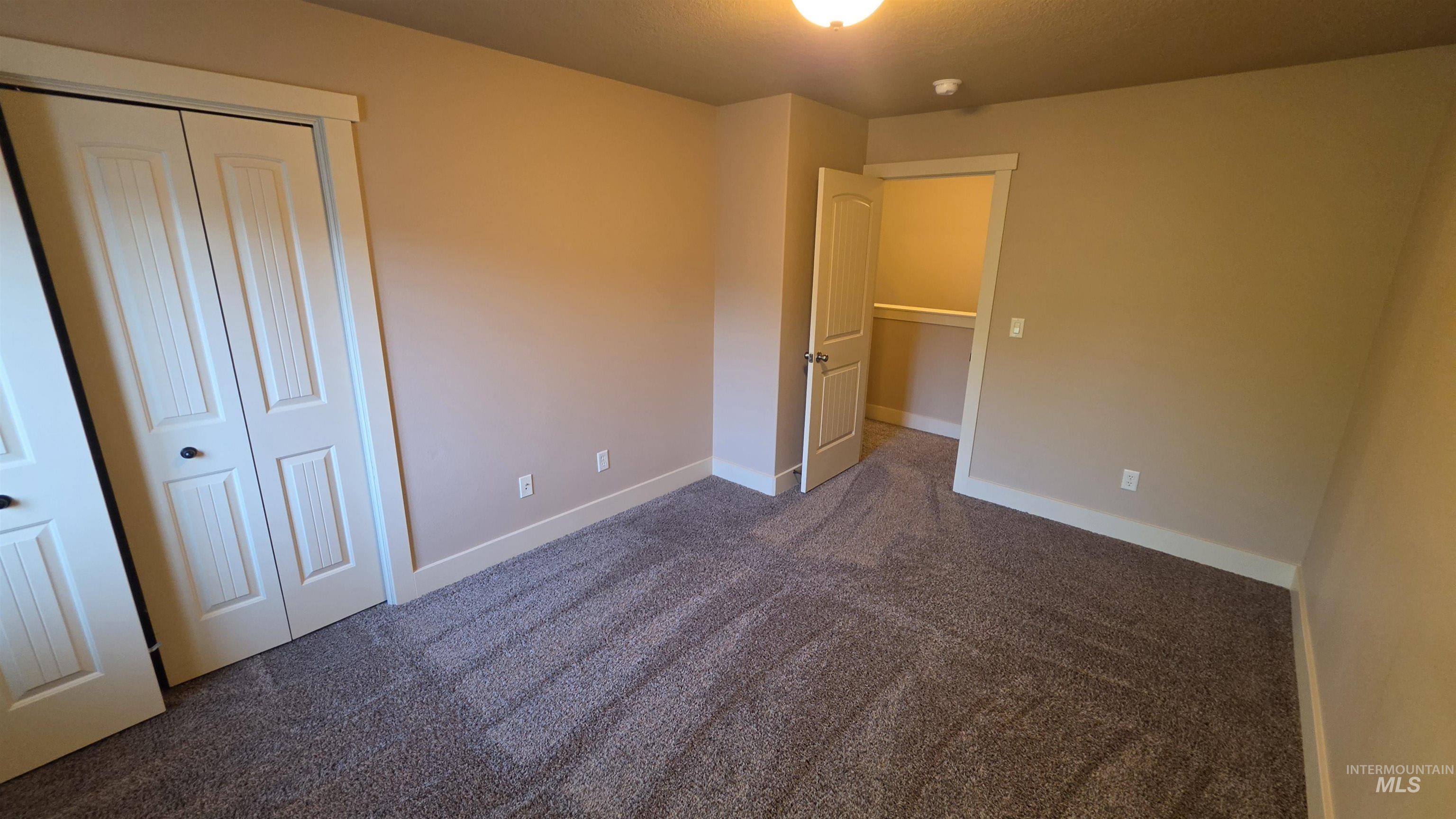 5239 West Morris Hill Road Boise, ID 83706 - Photo 19 of 19 Carpeted room featuring neutral wall tones, white trim, and a ceiling-mounted light fixture