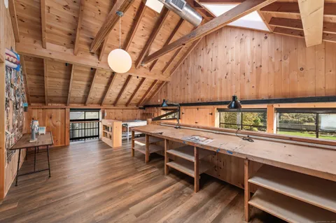 a kitchen with stainless steel appliances a stove and wooden floors