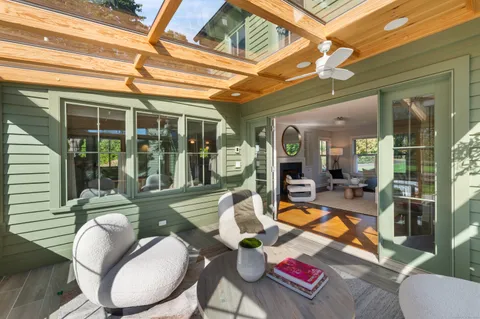 a living room with furniture a window and potted plants