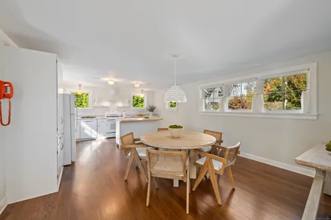a dining room with furniture and wooden floor