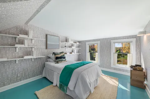 a bedroom with a bed and window