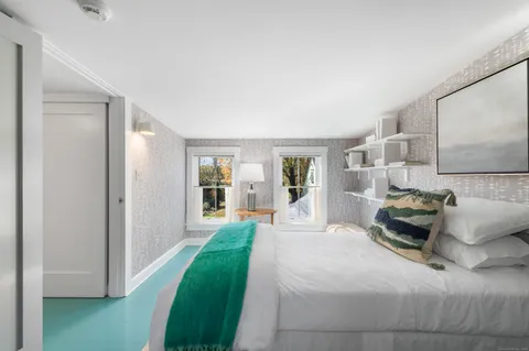 a bedroom with a bed and window