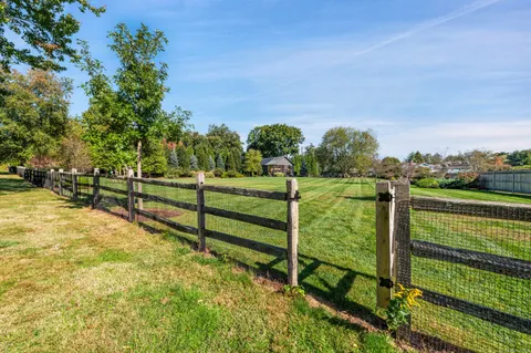 a view of a yard with wooden fence