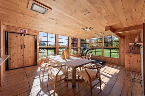 a view of a dining room with furniture window and wooden floor