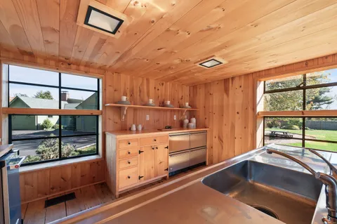 a kitchen with stainless steel appliances granite countertop a sink and cabinets