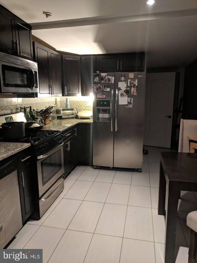 2603 Almond Street Philadelphia, PA 19125 - Photo 1 of 6 a kitchen with stainless steel appliances granite countertop a stove a sink and a refrigerator