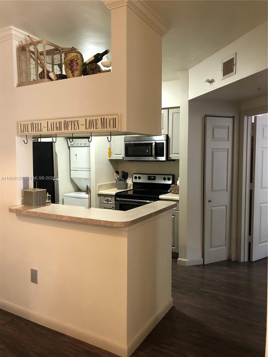 17150 North Bay Road, Unit 2422 Sunny Isles Beach, FL 33160 - Photo 2 of 9 a kitchen with a refrigerator and a stove