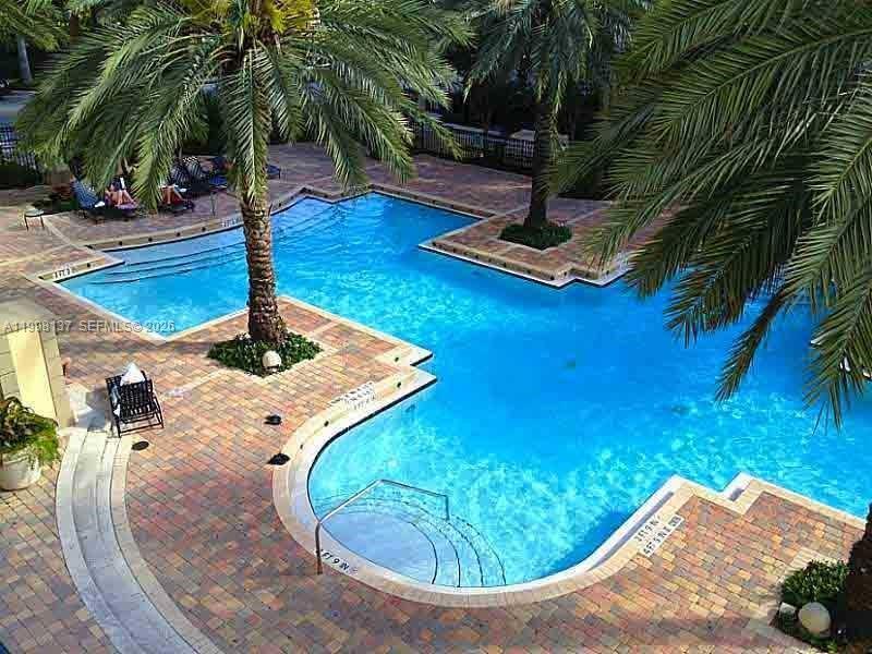 17150 North Bay Road, Unit 2422 Sunny Isles Beach, FL 33160 - Photo 5 of 9 a view of a swimming pool with lounge chair