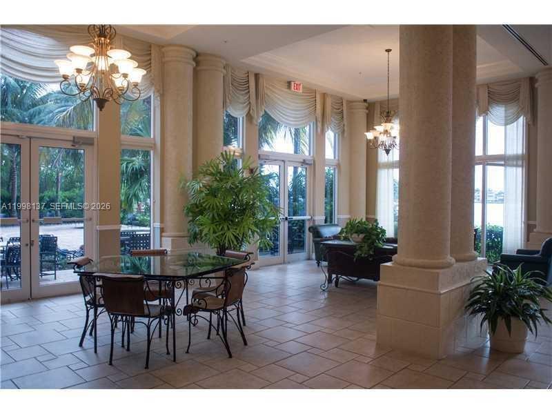 17150 North Bay Road, Unit 2422 Sunny Isles Beach, FL 33160 - Photo 9 of 9 a view of a dining room with furniture wooden floor and chandelier