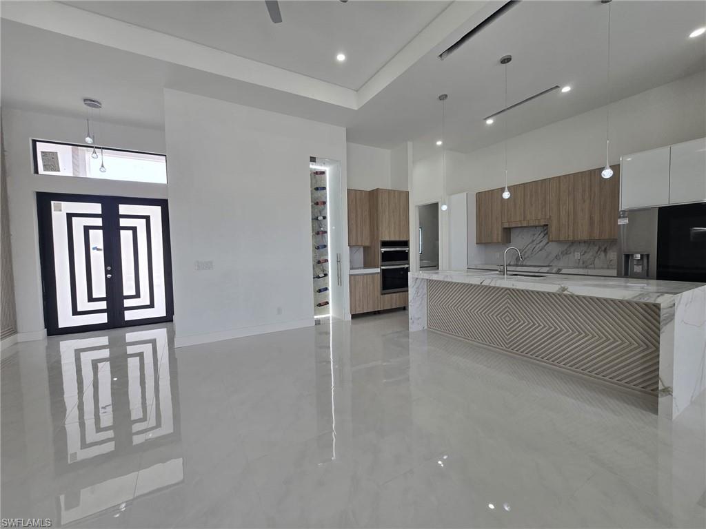 2006 Nelson Road North Cape Coral, FL 33993 - Photo 11 of 50 a large kitchen with a large counter top stainless steel appliances and cabinets