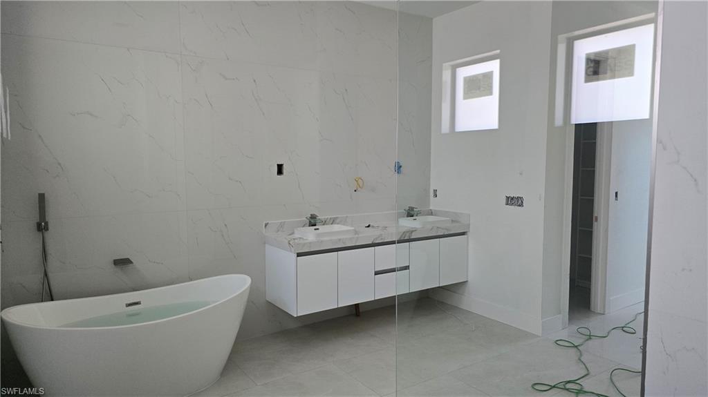 2006 Nelson Road North Cape Coral, FL 33993 - Photo 29 of 50 a bathroom with a tub and sink