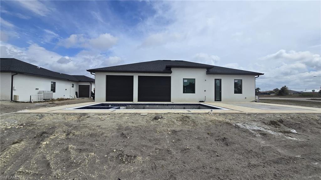 2006 Nelson Road North Cape Coral, FL 33993 - Photo 3 of 50 a front view of a house with a yard and garage