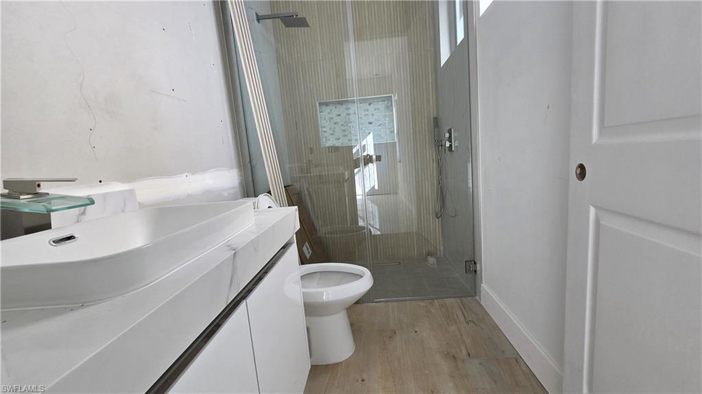 2006 Nelson Road North Cape Coral, FL 33993 - Photo 36 of 50 a bathroom with a sink a toilet and shower