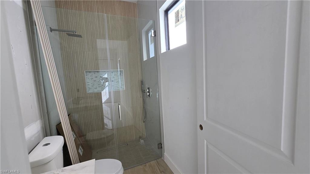 2006 Nelson Road North Cape Coral, FL 33993 - Photo 37 of 50 a bathroom with a shower and toilet