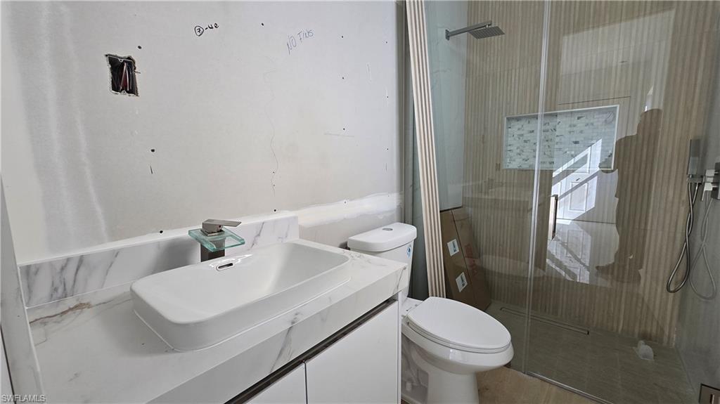 2006 Nelson Road North Cape Coral, FL 33993 - Photo 38 of 50 a bathroom with a sink toilet and shower