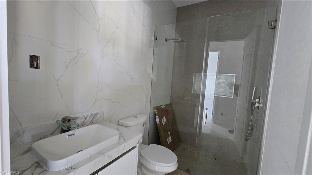 2006 Nelson Road North Cape Coral, FL 33993 - Photo 43 of 50 a bathroom with a sink toilet and shower